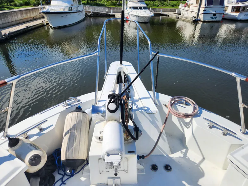 Slide: The Image of 1979 Hatteras 58 Long Range Cruiser bow view at marina dock. - 25
