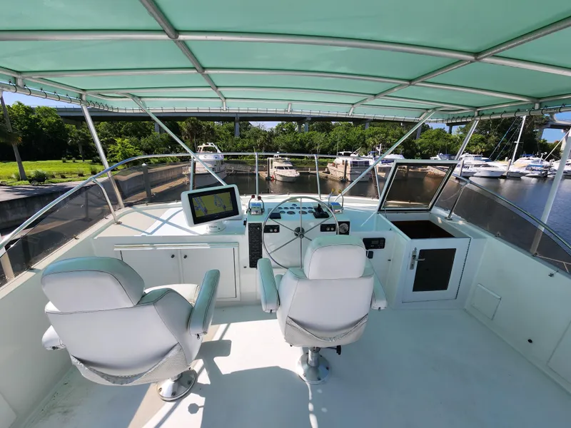 Slide: The Image of 1979 Hatteras 58 Long Range Cruiser helm with dual seats and navigation equipment. - 31