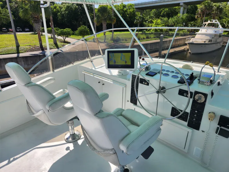 Slide: The Image of Helm of 1979 Hatteras 58 Long Range Cruiser with dual seats and navigation equipment. - 34