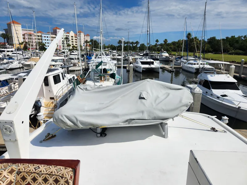 Slide: The Image of 1979 Hatteras 58 Long Range Cruiser docked at a marina with other boats. - 40