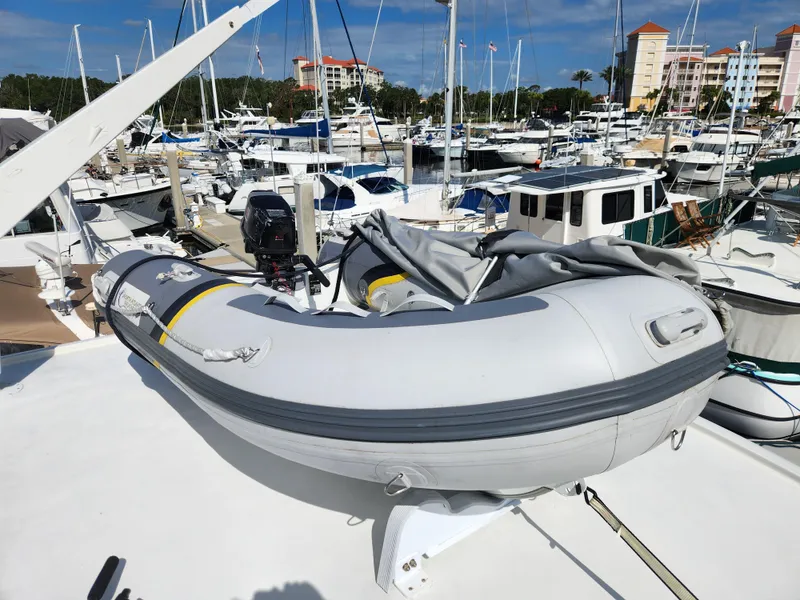 Slide: The Image of Inflatable dinghy on 1979 Hatteras 58 Long Range Cruiser, docked in a marina. - 42