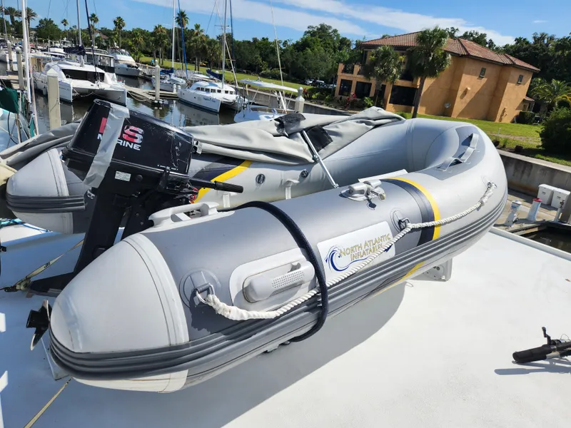 Slide: The Image of Inflatable boat with outboard motor on 1979 Hatteras 58 Long Range Cruiser deck. - 43