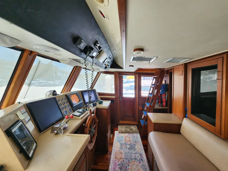 Slide: The Image of 1979 Hatteras 58 Long Range Cruiser interior with navigation equipment and wooden finishes. - 45