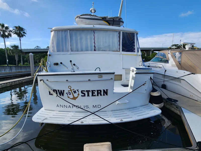 Slide: The Image of 1979 Hatteras 58 Long Range Cruiser docked in Annapolis, MD, with clear blue sky. - 6