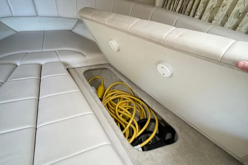 Slide: The Image of Interior storage compartment of 2000 Formula 330 SS boat with coiled yellow cables. - 11