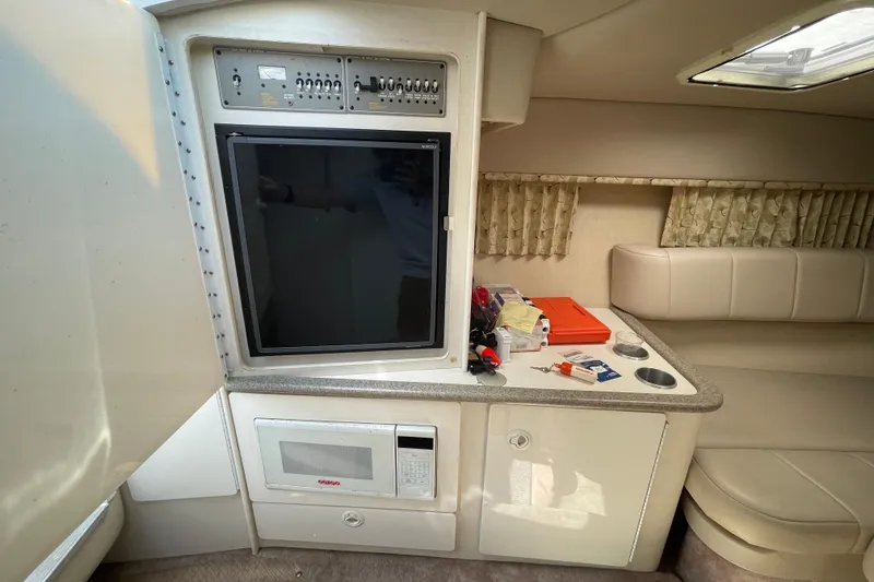 Slide: The Image of Interior of 2000 Formula 330 SS boat with TV, microwave, and seating area. - 12