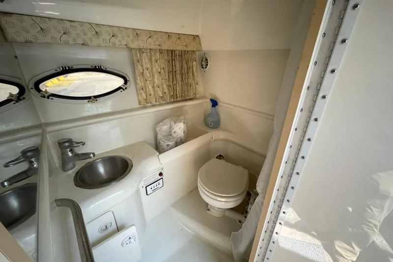 Slide: The Image of Interior of a 2000 Formula 330 SS boat bathroom with sink and toilet. - 13