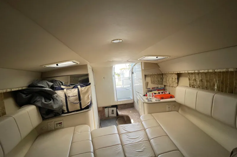 Slide: The Image of Interior of a 2000 Formula 330 SS boat with beige seating and storage. - 14