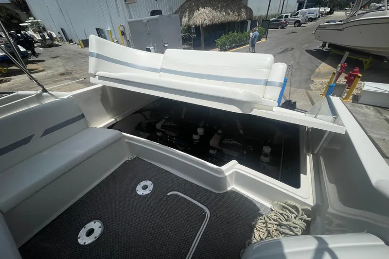 Slide: The Image of 2000 Formula 330 SS boat with open engine compartment, docked at a marina. - 17