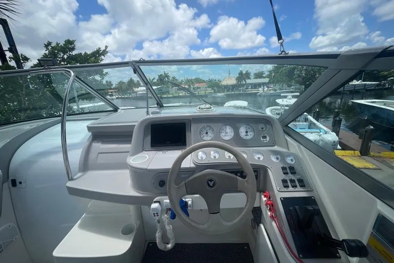 Slide: The Image of Cockpit view of a 2000 Formula 330 SS boat, featuring steering wheel and instrument panel. - 19