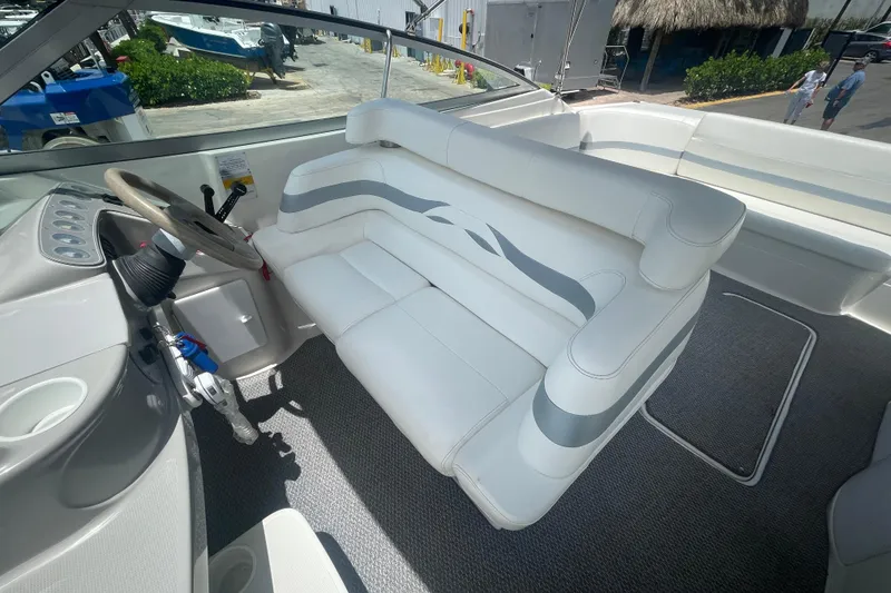 Slide: The Image of Interior of a 2000 Formula 330 SS boat with white seating and steering wheel. - 22