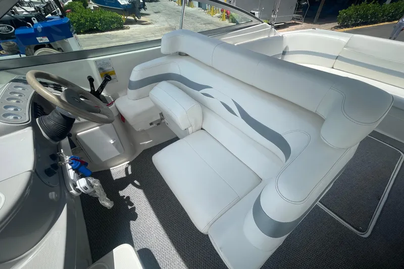 Slide: The Image of Interior of a 2000 Formula 330 SS boat with white seating and steering wheel. - 23