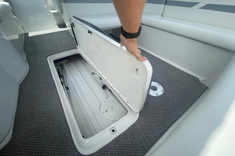Slide: The Image of Man opening storage compartment on 2000 Formula 330 SS boat deck. - 24