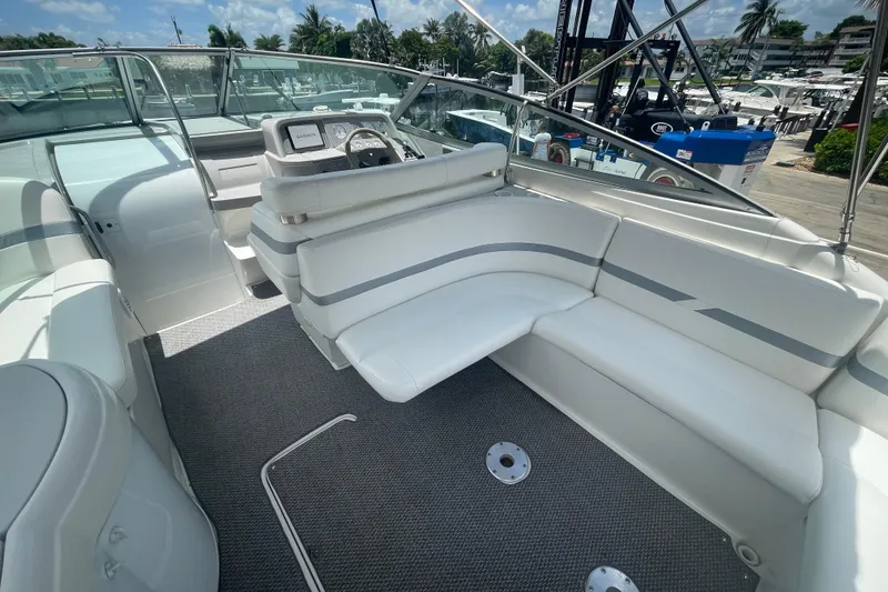 Slide: The Image of Interior of 2000 Formula 330 SS boat with white seating and modern dashboard. - 25