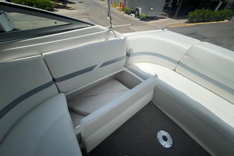 Slide: The Image of 2000 Formula 330 SS boat interior with white seating and storage compartment. - 26