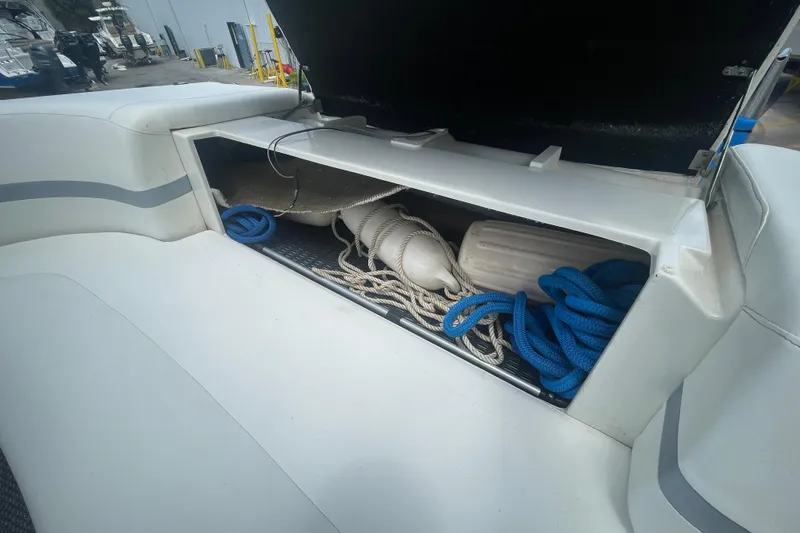 Slide: The Image of Open storage compartment on a 2000 Formula 330 SS boat with ropes and fenders. - 30