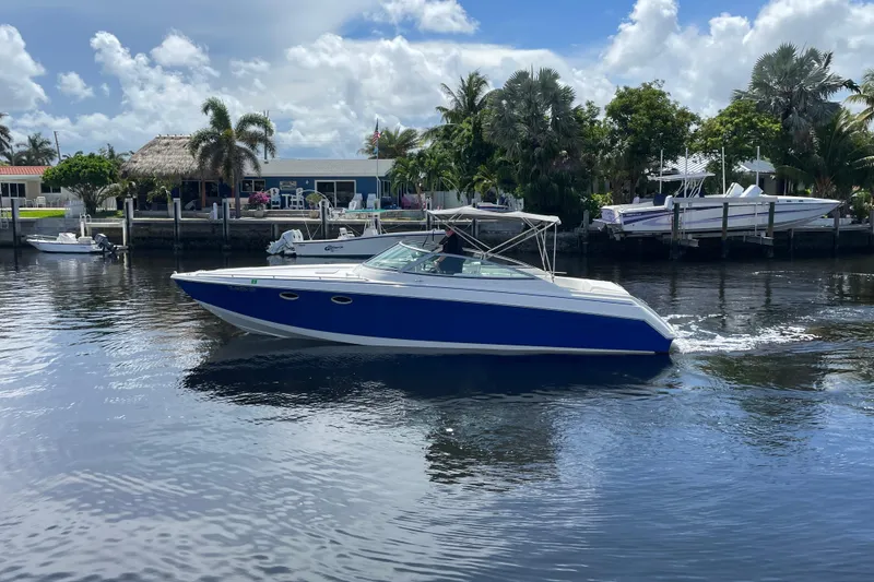 Slide: The Image of 2000 Formula 330 SS boat cruising on a sunny day near a waterfront. - 33