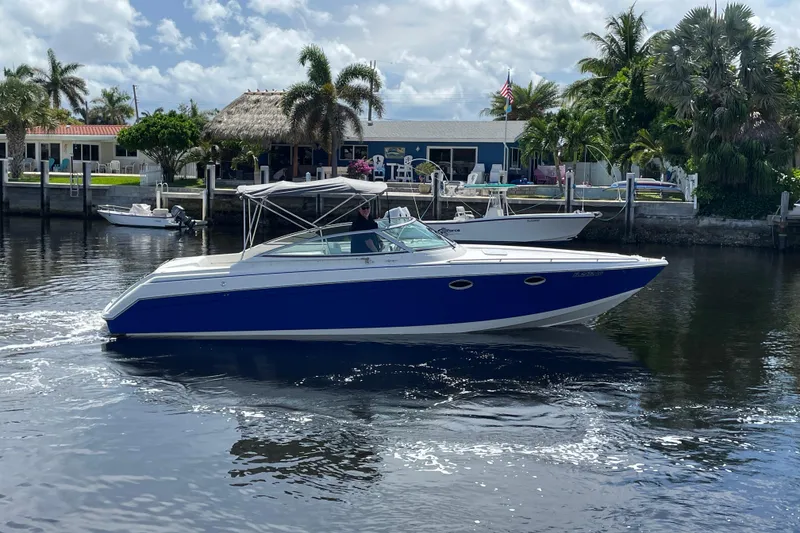 Slide: The Image of 2000 Formula 330 SS boat cruising on a sunny day near waterfront homes. - 39