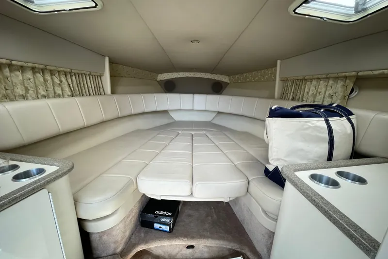 Slide: The Image of Interior of 2000 Formula 330 SS boat with beige seating and storage. - 9