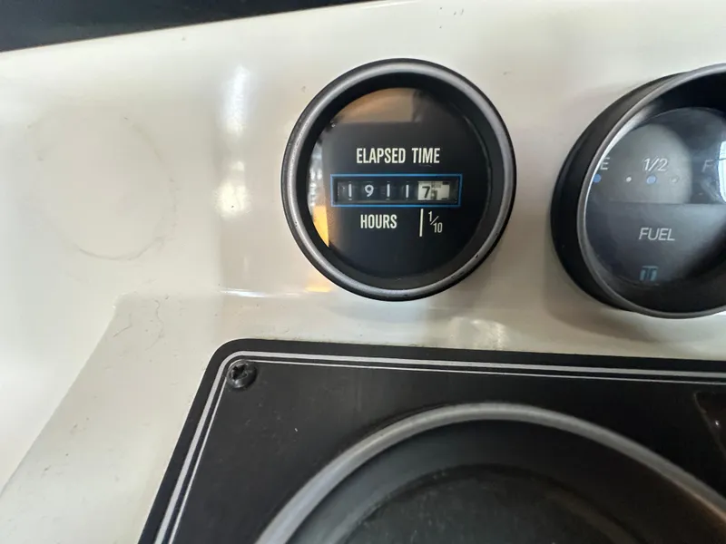 Slide: The Image of 1988 Carver 280 Voyager dashboard showing elapsed time and fuel gauge. - 14