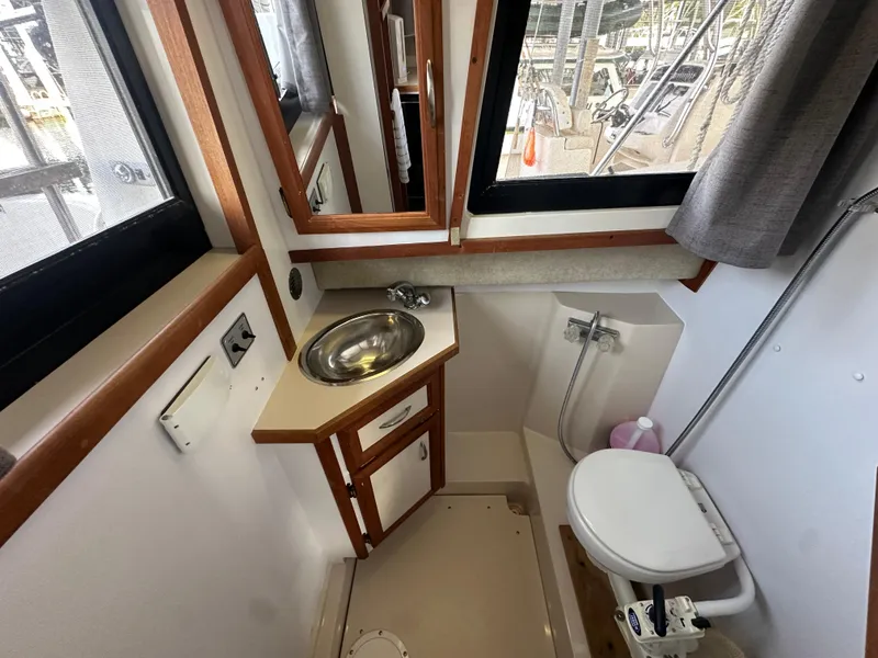 Slide: The Image of Compact bathroom in 1988 Carver 280 Voyager boat with sink, toilet, and window. - 16