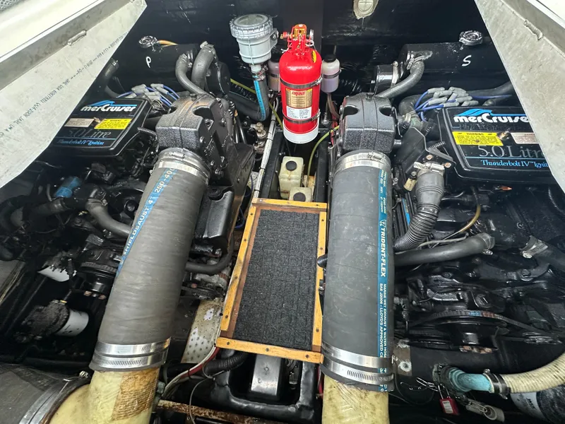 Slide: The Image of Engine compartment of a 1988 Carver 280 Voyager with MerCruiser 5.0L engines and fire extinguisher. - 25