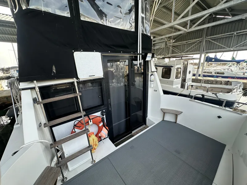 Slide: The Image of 1988 Carver 280 Voyager boat interior with ladder, life preserver, and docked marina view. - 5