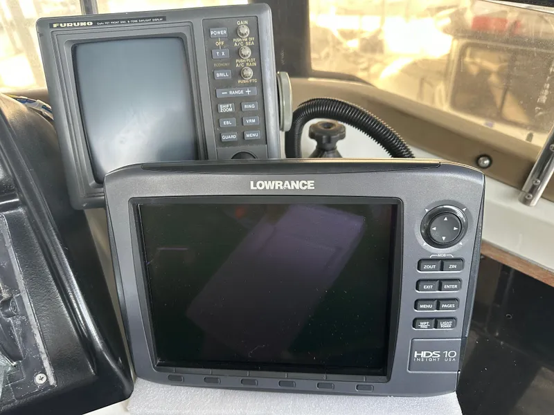Slide: The Image of Lowrance and Furuno marine navigation systems on a 1988 Carver 280 Voyager boat. - 7