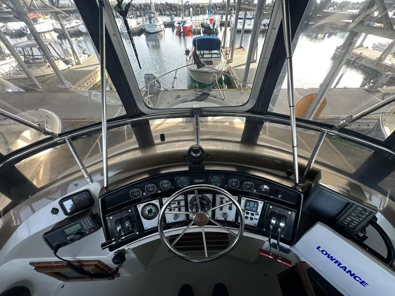 Slide: The Image of Interior view of 1988 Carver 280 Voyager boat cockpit with steering wheel and navigation equipment. - 10