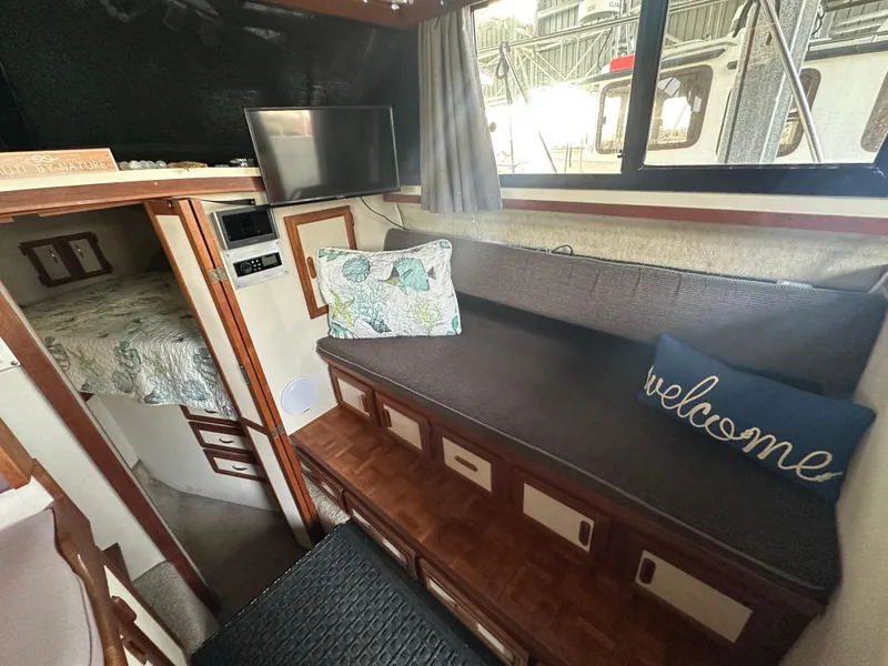 Slide: The Image of Interior of 1988 Carver 280 Voyager boat with cozy seating and welcome pillow. - 12