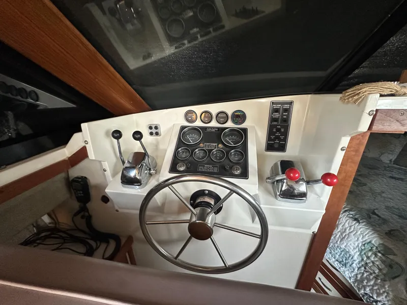 Slide: The Image of 1988 Carver 280 Voyager helm with steering wheel, gauges, and controls. - 13