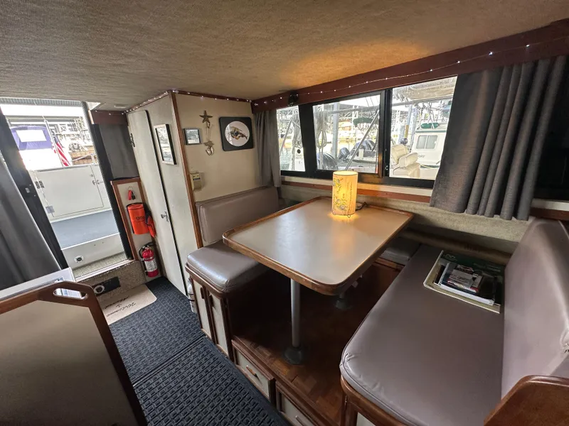 Slide: The Image of Interior of 1988 Carver 280 Voyager boat with dining area and window view. - 15
