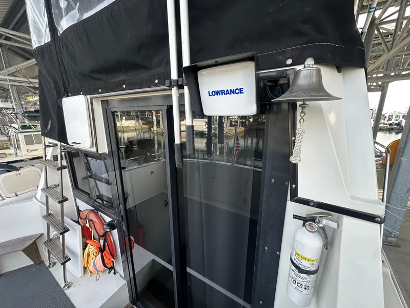 Slide: The Image of 1988 Carver 280 Voyager boat with Lowrance equipment, life jackets, and fire extinguisher on deck. - 21