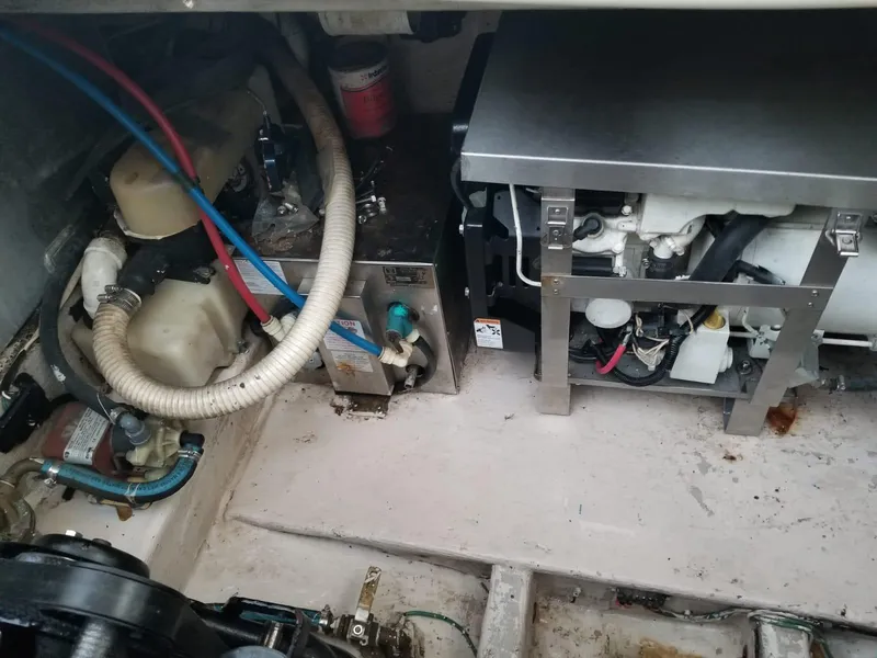 Slide: The Image of Engine compartment of a 2000 Wellcraft 3000 Martinique boat, showing mechanical components. - 12