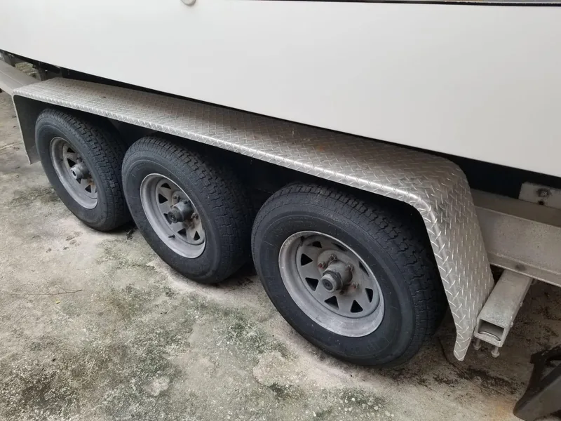 Slide: The Image of Triple-axle trailer for 2000 Wellcraft 3000 Martinique boat, featuring diamond plate fender. - 15