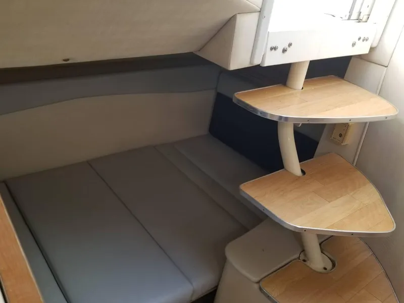 Slide: The Image of Interior cabin of 2000 Wellcraft 3000 Martinique with wooden steps and cushioned seating. - 4