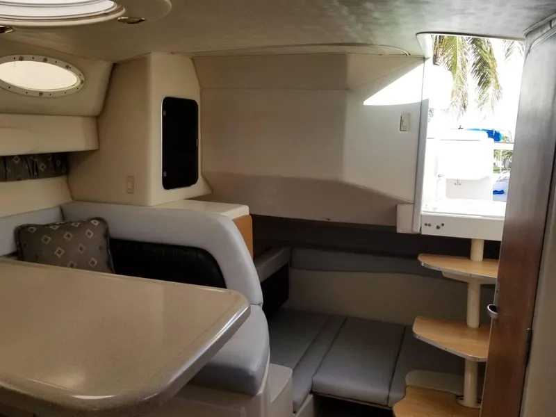 Slide: The Image of Interior of 2000 Wellcraft 3000 Martinique boat, featuring seating and a small table. - 5