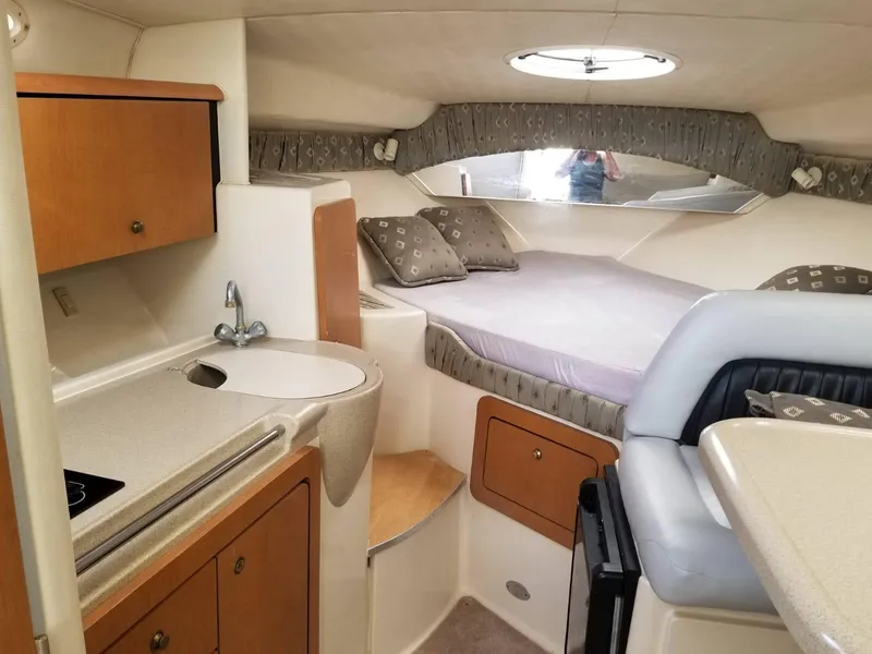 Slide: The Image of 2000 Wellcraft 3000 Martinique cabin interior with kitchenette and bed. - 7
