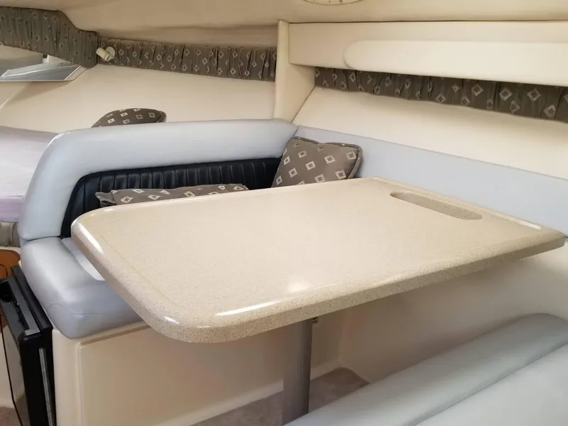 Slide: The Image of Interior of 2000 Wellcraft 3000 Martinique boat with dining area and cushioned seating. - 8