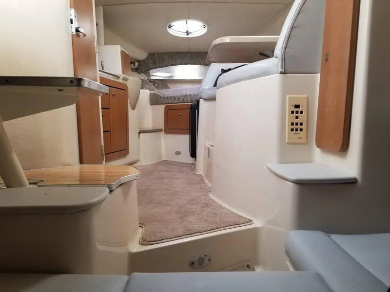 Slide: The Image of Interior of 2000 Wellcraft 3000 Martinique boat, featuring cozy cabin and seating area. - 9