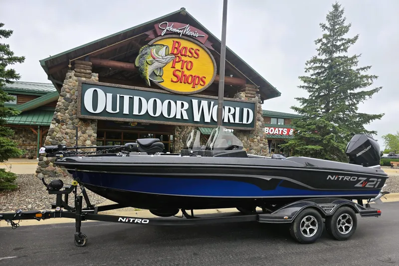 The Image of 2025 Nitro ZV21 boat displayed outside Bass Pro Shops Outdoor World. - 0