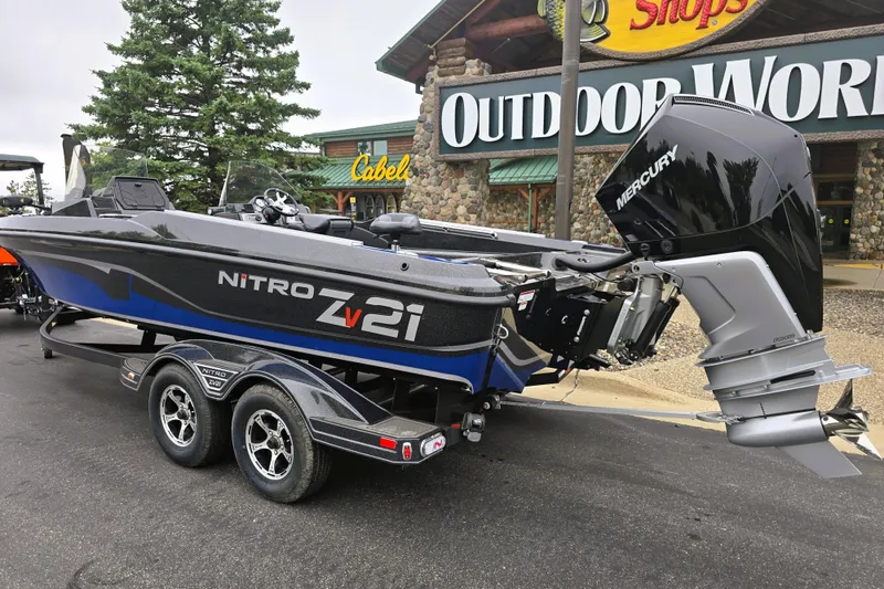 Slide: The Image of 2025 Nitro ZV21 boat with Mercury engine outside Outdoor World store. - 1