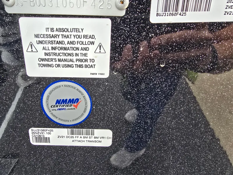 Slide: The Image of Close-up of Nitro ZV21 boat certification and warning labels, emphasizing safety instructions. - 6