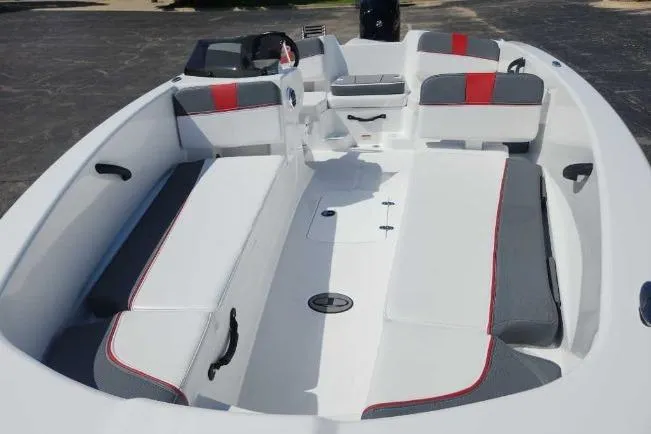Slide: The Image of 2025 Tahoe T18 boat interior with white and gray seating, red accents, and spacious layout. - 6