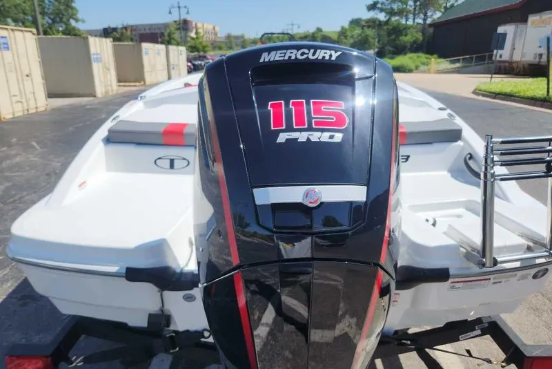 Slide: The Image of 2025 Tahoe T18 boat with Mercury 115 Pro outboard motor, parked outdoors. - 70