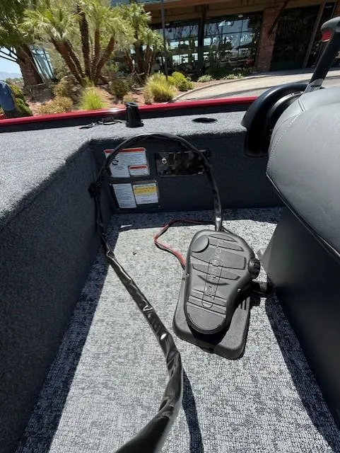 Slide: The Image of Interior of 2025 Tracker Panfish 17 boat showing foot pedal and carpeted floor. - 14
