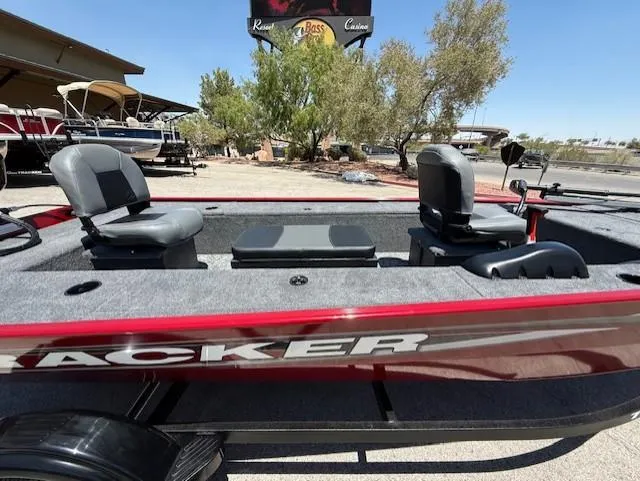 Slide: The Image of 2025 Tracker Panfish 17 boat with dual seats, parked outdoors under clear skies. - 3