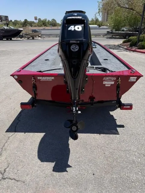 Slide: The Image of 2025 Tracker Panfish 17 boat with Mercury 40 engine, parked outdoors. - 4