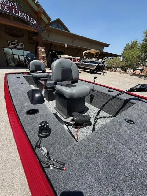Slide: The Image of 2025 Tracker Panfish 17 boat with seating, displayed at a boat service center. - 7