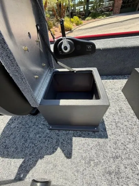 Slide: The Image of 2025 Tracker Panfish 17 boat storage compartment with open lid, showcasing interior space. - 8